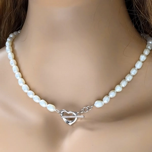Close-up of 925 silver heart-shaped OT clasp on a natural freshwater pearl necklace