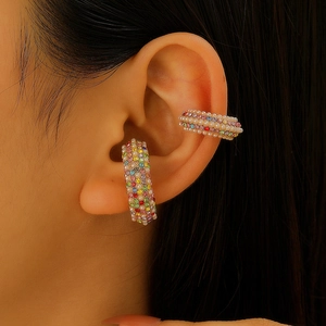 Luxe C-shaped ear cuff featuring colorful rhinestones and pearls worn by a model
