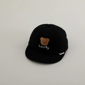 Detail of embroidered bear and Lucky text on a black cotton baby baseball cap