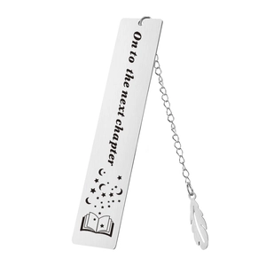 Macro shot of silver metal bookmark with 'On to the next chapter' text and feather charm