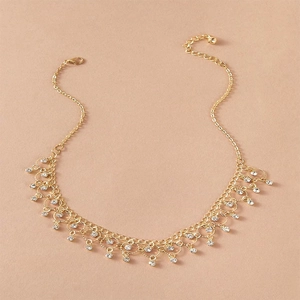 Gold layered choker necklace with sparkling zircon droplets and tassel fringe detail