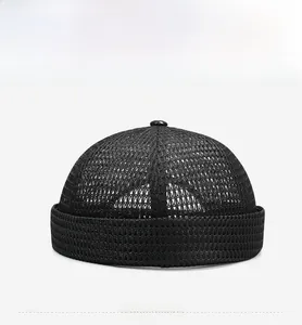 Close-up of breathable black mesh fabric and top button on a docker brimless hat