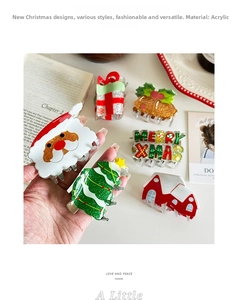 Detail of glittery Christmas claw clips set showing Santa and Xmas tree acrylic designs