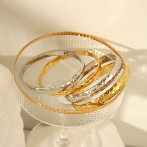 Polished 18k gold and silver stainless steel bangles with diamond cut pattern