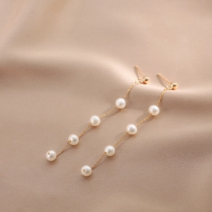 Elegant long gold chain earrings featuring multiple white natural freshwater pearls on silk