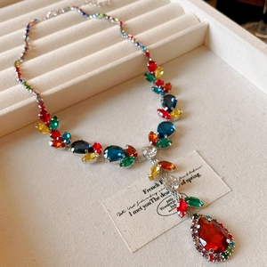 Close-up of leaf and waterdrop pendant necklace with vibrant multi-color zircons