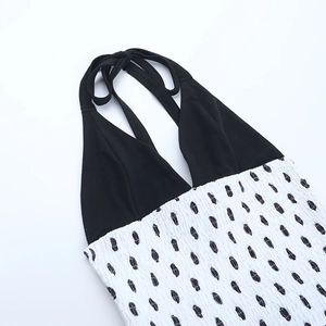 Detail of halter neck design and smocked contrast stitching on a polka dot dress