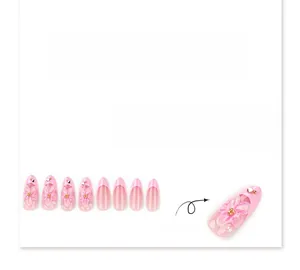 Macro detail of 3D pink floral relief and pearls on short almond French press-on nails
