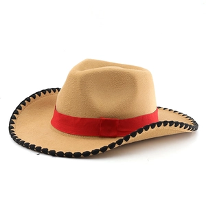 Detail of camel cowboy hat with red ribbon and black wavy stitching on the wide brim