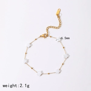 Detailed macro view of 2.1g gold steel bracelet with six 6.5mm white star charms