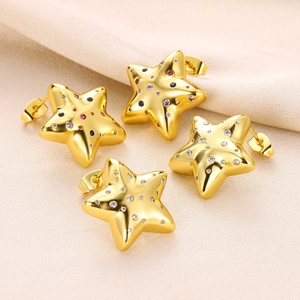 Elegant gold star earrings with colorful and white zircon inlay on beige fabric