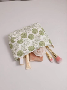 Linen makeup bag with green floral embroidery and metal zipper for cosmetics storage