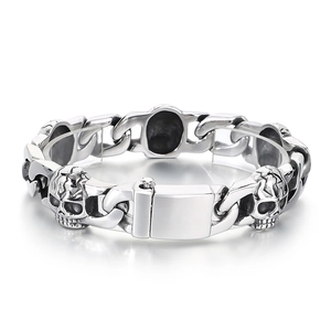 Silver Cuban chain bracelet with skull charms in polished stainless steel for men