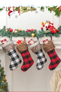 Detail of buffalo plaid Christmas stockings with faux fur trim in a fireplace scene
