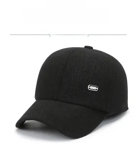 Detail of wool texture and metal accent on black winter baseball hat with ear protection