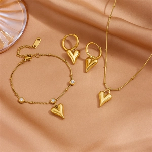 Golden stainless steel jewelry set with heart pendants including necklace and bracelet