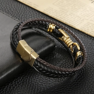 Macro shot of multi-layer braided leather bracelet with gold brushed metal clasp