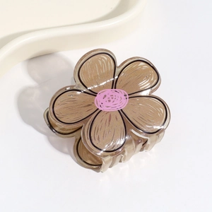 Detail of coffee brown flower hair claw clip with pink center in semi-transparent resin