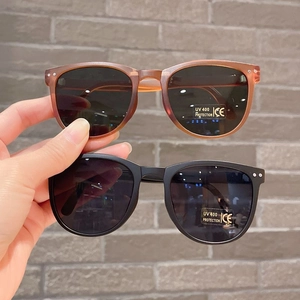 Detail of foldable kids sunglasses with UV400 protection in brown and black colors