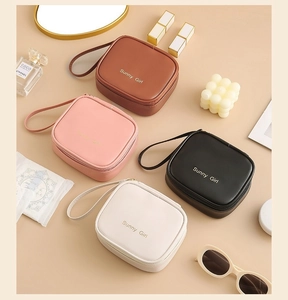 Flat lay of colorful waterproof PU leather sanitary pouches with gold Sunny Girl logo