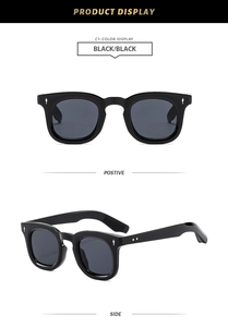 Detail view showing black round-frame sunglasses with silver arrow accents and metal dots