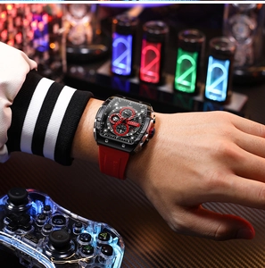 Close-up of CURREN chronograph watch with red silicone strap in gaming environment