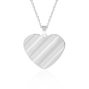 Detailed view of a silver heart pendant with textured stripes on a metal chain link