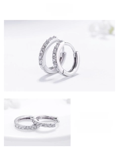 Macro shot of S925 sterling silver huggie earrings with shimmering pavé cubic zirconia
