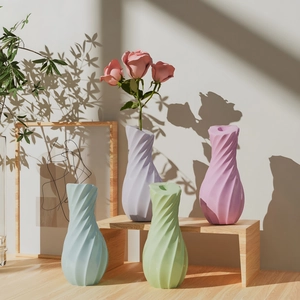 Detailed view of modern spiral textured flower vases in pastel blue, lilac, and soft green
