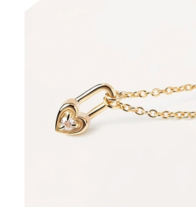 Macro shot of gold heart-shaped lock pendant necklace with a brilliant center diamond