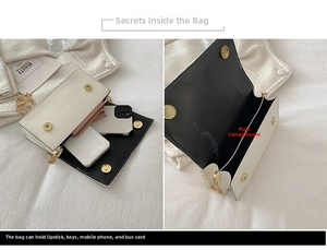 Detail view of the black and white handbag showing interior capacity for phone and lipstick