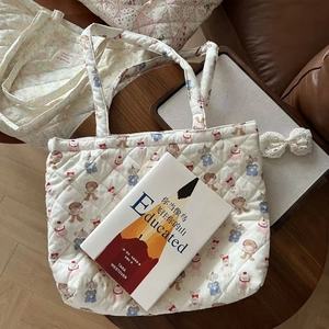 Close-up of quilted animal print tote bag featuring cute bears on a brown leather sofa