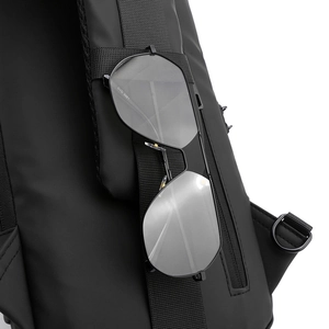 Detail of water-resistant black chest bag showing the sunglasses holder on shoulder strap