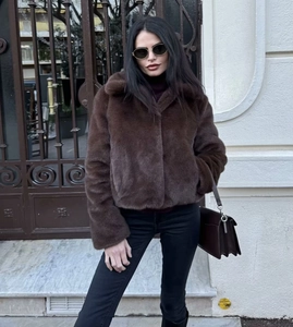 Detail of a brown faux fur jacket with a large notched lapel for autumn and winter