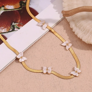 Close-up of 18K gold-plated blade chain with delicate white shell butterfly charms