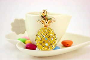 Close-up of sparkling rhinestone pineapple keychain with golden leaf and metal ring