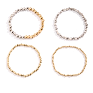 Detailed grid view of metal beaded bracelets in gold and silver finish with heart charm