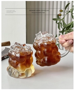 Detail of embossed grape texture glass cup with handle and iced coffee display