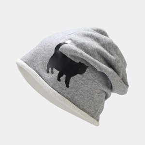 Détail du bonnet en tricot gris avec imprimé chat noir et texture en coton doux