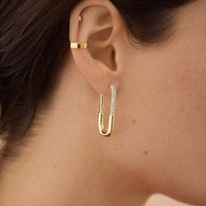 18K gold paperclip earrings with micro-pave crystals shown on a female model