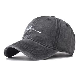 Detail of washed cotton baseball cap featuring white Mama script embroidery on charcoal grey