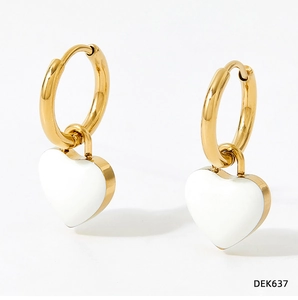 Detail of gold hoop earrings with white heart oil-dripping charms on a clean background