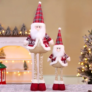 Detail of telescopic Santa Claus figurines with red plaid in a warm home fireplace setting