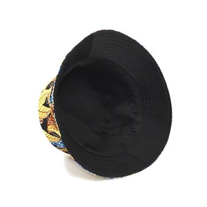 Vue détaillée d'un chapeau bob réversible avec motif de feuilles jaunes et doublure noire