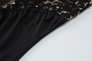 Detailed close-up of premium black eyelash lace and smooth fabric stitching on dress