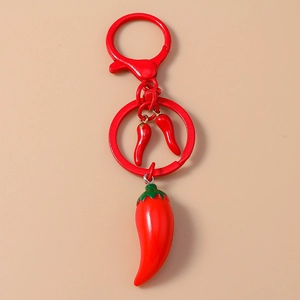 Close-up of creative red chili pepper keychain with realistic resin texture and metal hook