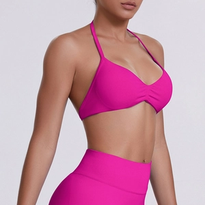 Detail of rose pink halter neck sports bra and high-waist seamless leggings yoga set