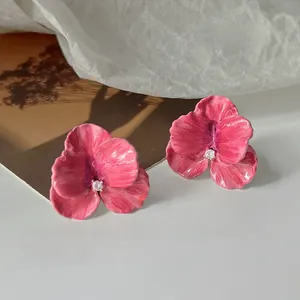 Close-up of elegant rose pink floral stud earrings with oil painting texture and zircon
