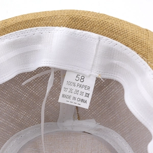 Detail of 100% paper straw hat interior with size 58 label and sweatband