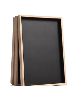 Detailed view of stacked solid wood jewelry trays with black velvet lining for display